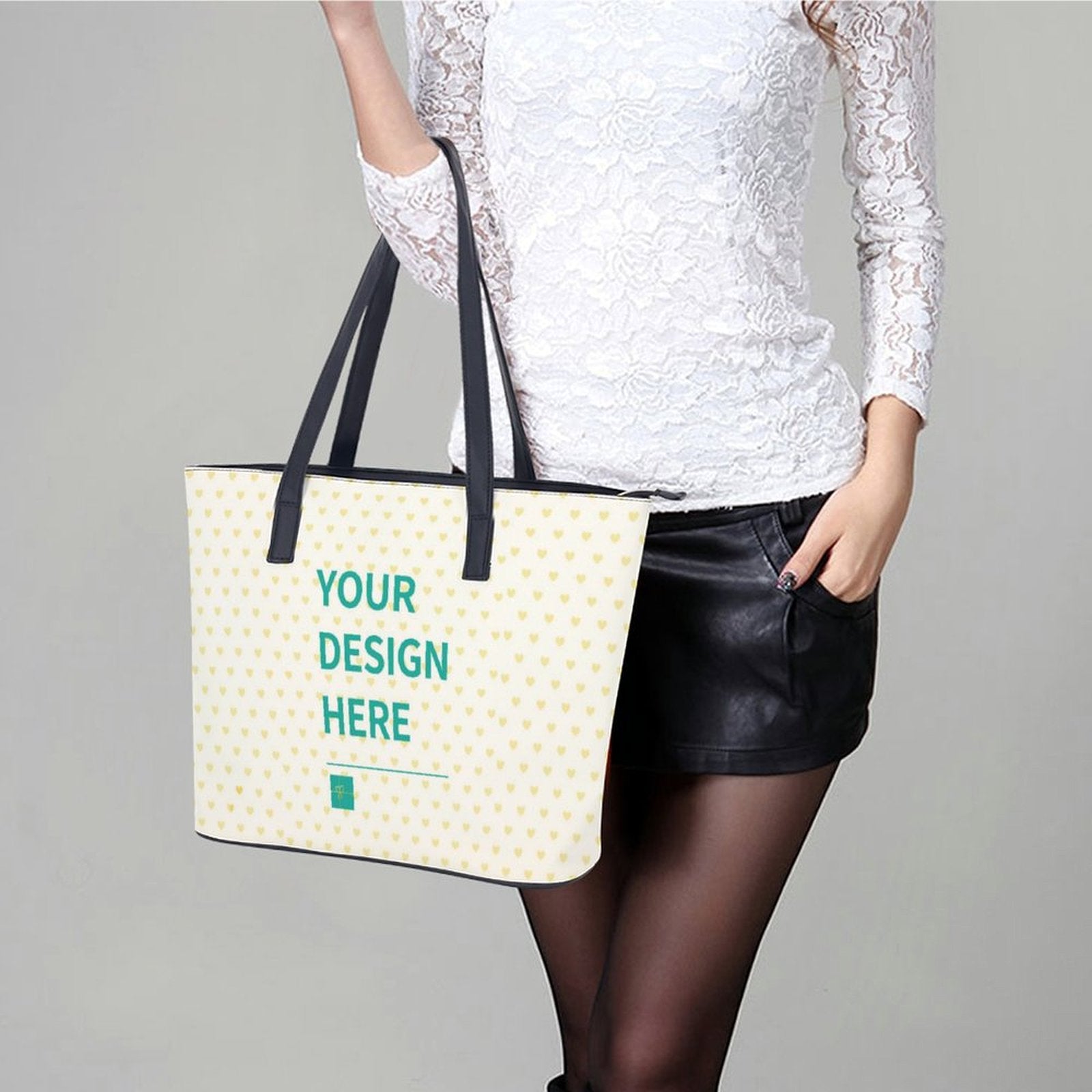 Customizable leather tote bag for women. Features black handles and "Your Design Here" text, perfect for shopping or travel.