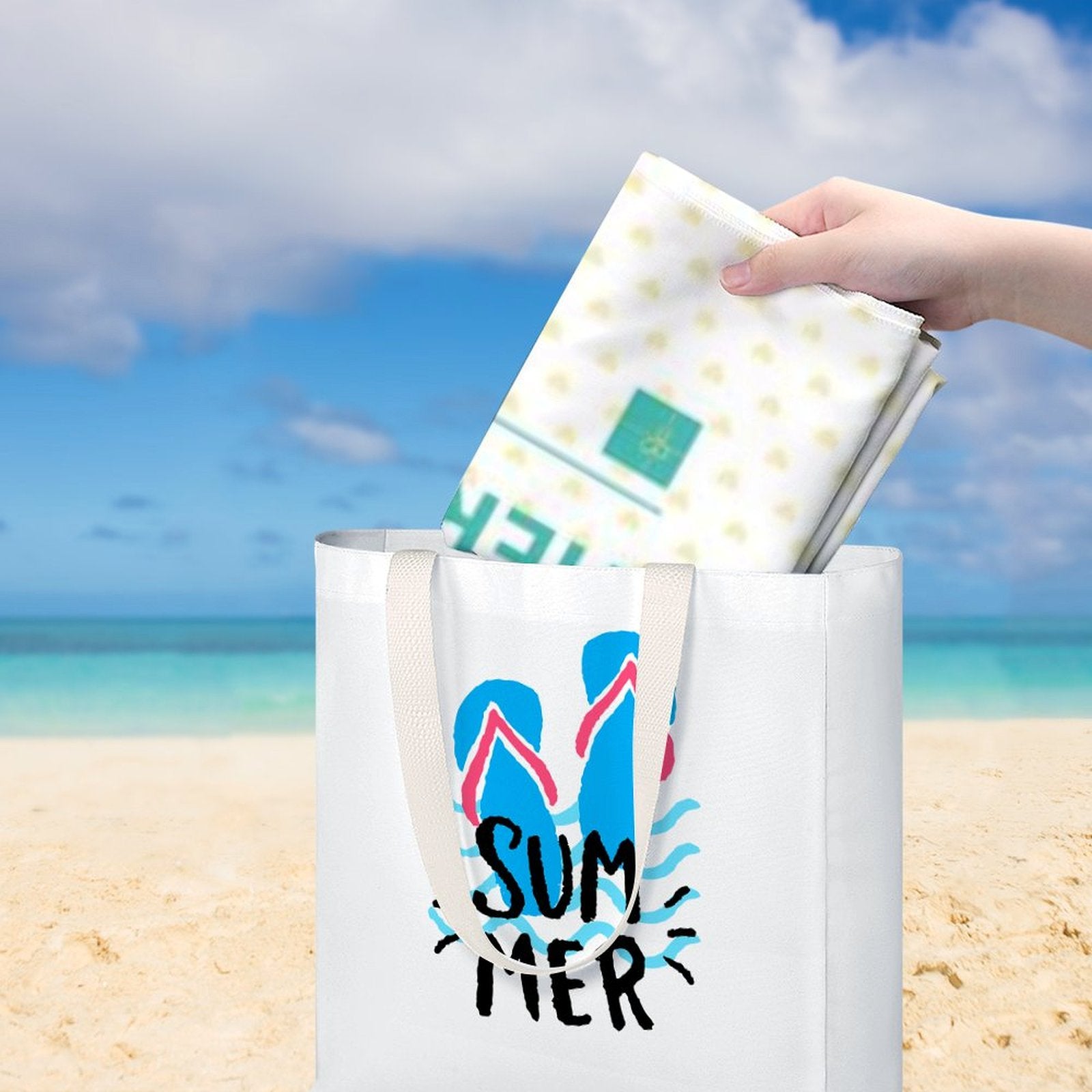Beach towel being placed into a tote bag with a summer flip-flop design, perfect for travel or beach use, from MyArtsyGift