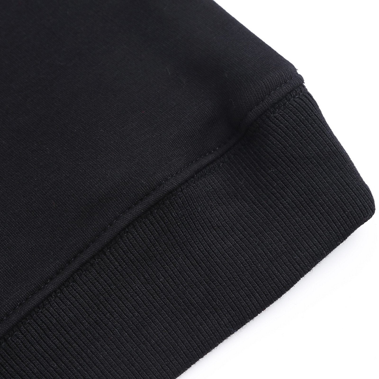 Black youth hoodie close-up detail, showing cotton fabric and ribbed cuff. Customizable youth sweatshirt.