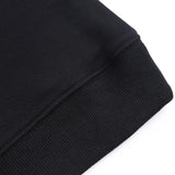 Black youth hoodie close-up detail, showing cotton fabric and ribbed cuff. Customizable youth sweatshirt.