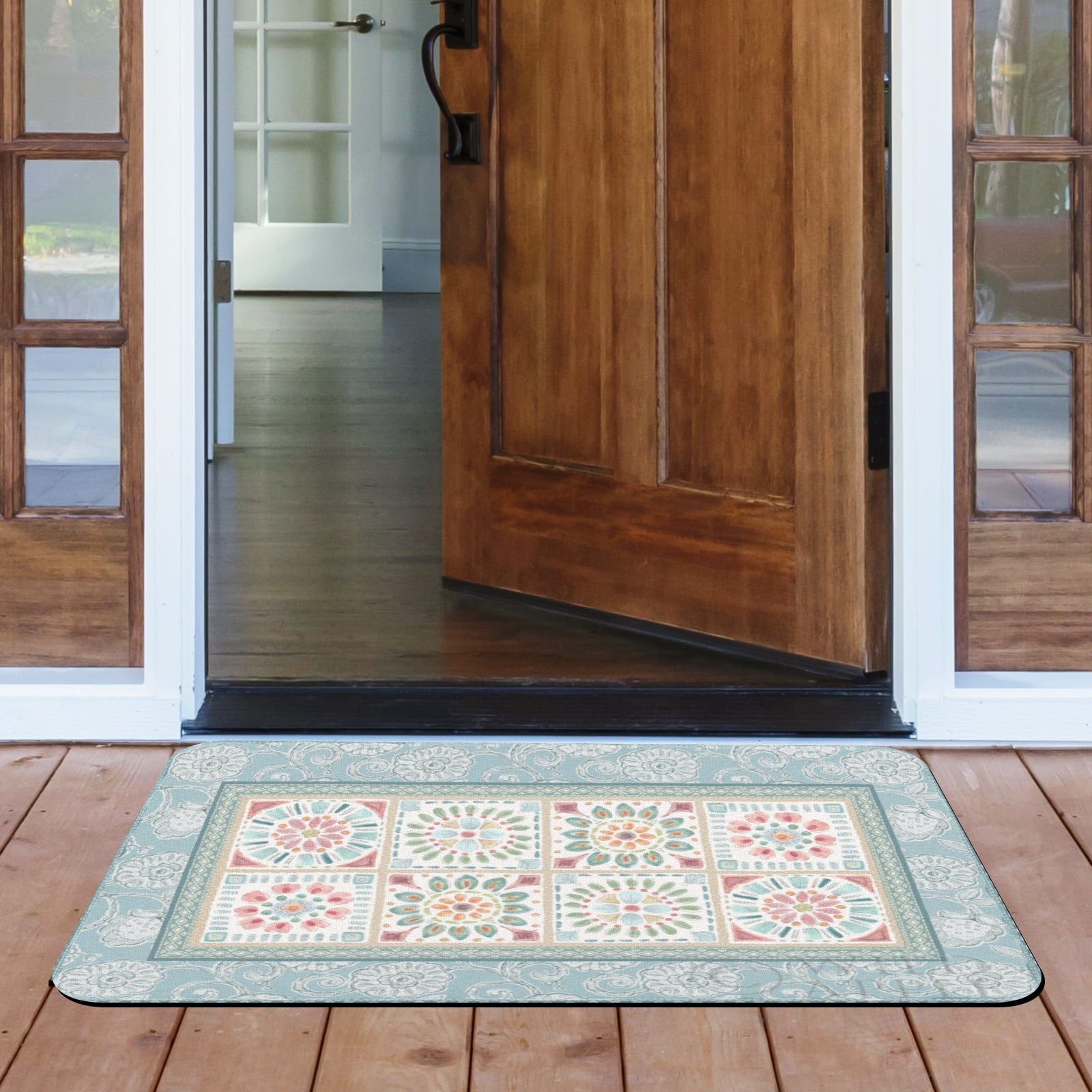 Blue floral door mat with desert design at a wooden door entrance for indoor and outdoor use