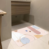 Pink abstract entrance doormat with geometric design and rubber backing for bathroom use