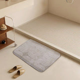 Coral velvet bath rug with abstract wave design in bathroom, non-slip and absorbent.