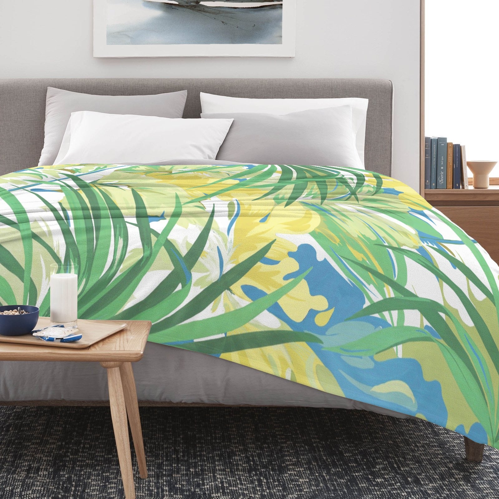 Green tropical plants flannel blanket on bed. Featuring vibrant floral design for couch or bed decor, made in USA.