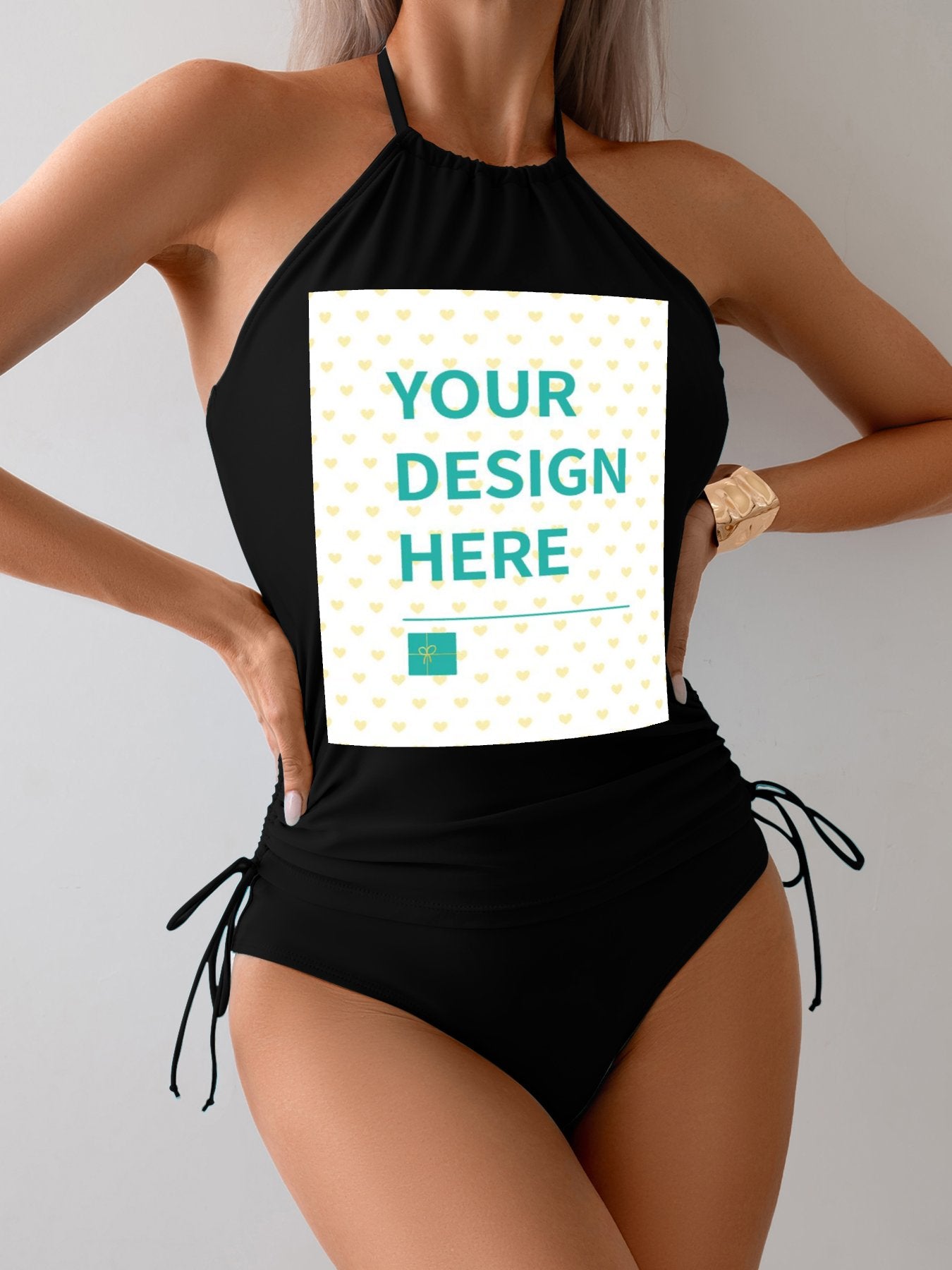Custom black swimsuit for women with halter neck featuring "YOUR DESIGN HERE" text, personalized swimwear