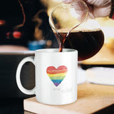 White ceramic mug with rainbow heart and "Love is Love" text, perfect Pride gift, being filled with coffee