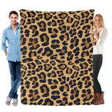 Animal skin flannel blanket in leopard print, featuring black and brown spots, perfect for home decor.
