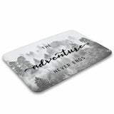 Coral velvet bath rug with "The adventure never ends" text and forest scene.