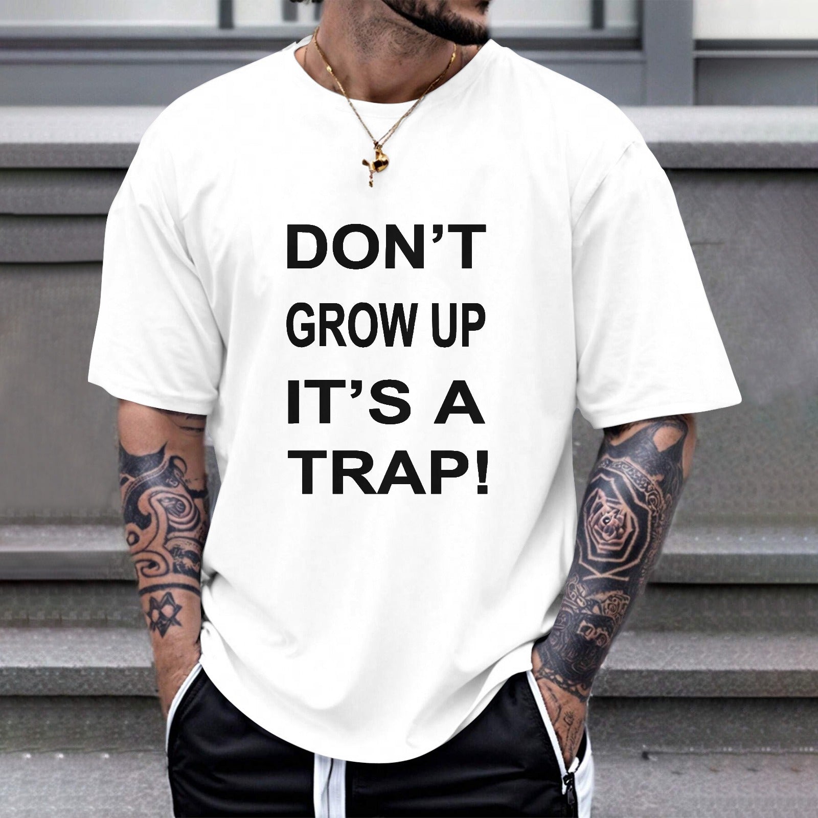 White cotton Gildan unisex T-shirt with "DON'T GROW UP IT'S A TRAP!" print, casual wear.