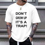 White cotton Gildan unisex T-shirt with "DON'T GROW UP IT'S A TRAP!" print, casual wear.