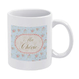 Personalized white ceramic coffee mug with floral design and "Ma Chérie" text, a customized gift.