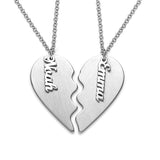 Personalized silver puzzle heart necklace for couples. 'Noah' and 'Emma' engraved on the pendant, a perfect custom gift