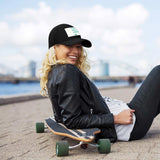 Customizable black baseball cap design with text "YOUR DESIGN HERE", women with skateboard, MyArtsyGift.