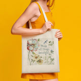 Canvas tote bag with floral print and 'Make all things beautiful' quote, perfect for shopping and everyday use.