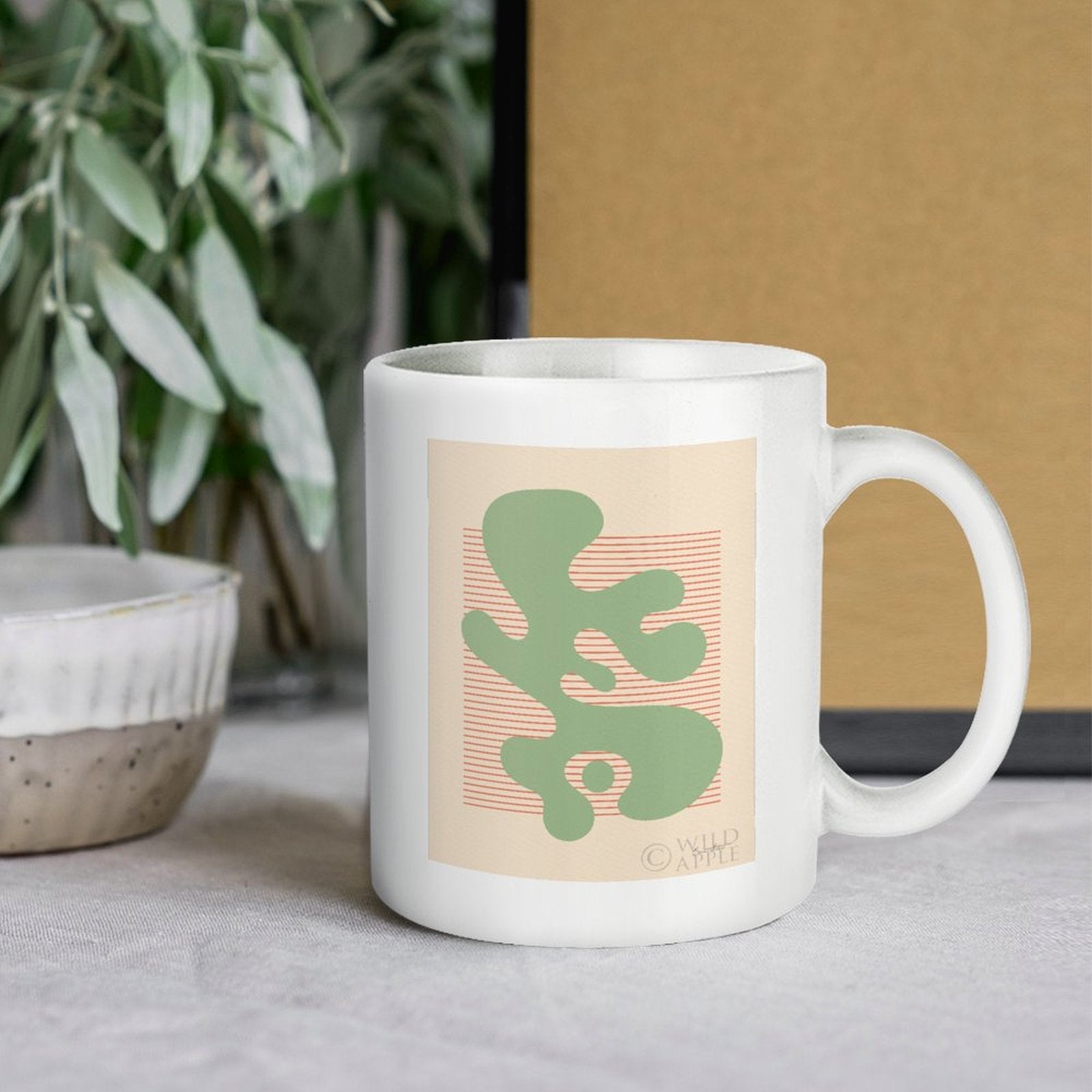 White ceramic coffee mug with green abstract design, Shape Up IV, by Wild Apple, a perfect personalized gift from MyArtsyGift