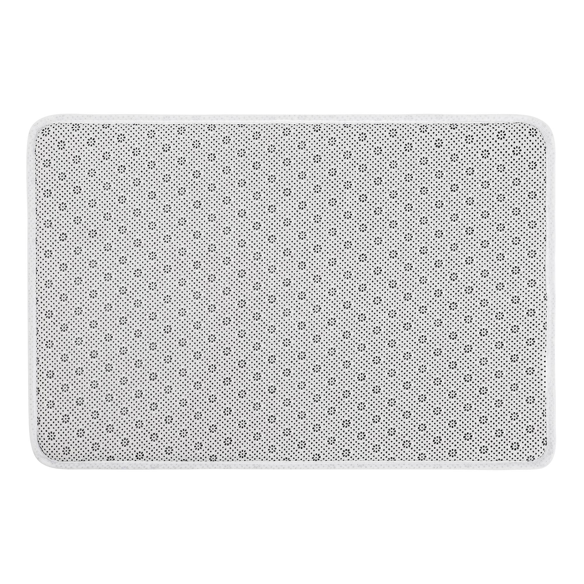 Non-slip doormat backing with black floral pattern and white edge, perfect for bathroom or bedroom