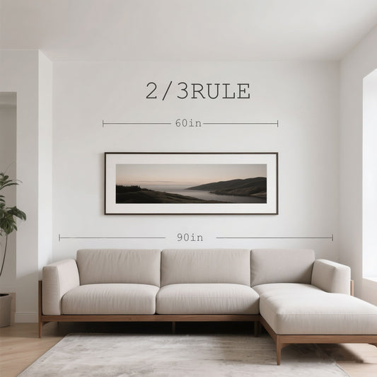 Modern living room demonstrating the 2/3 rule with framed landscape wall art positioned above neutral sectional sofa for perfect proportions.