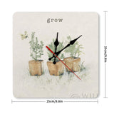 Square wall clock with watercolor plants and 'grow' text; ideal for home or kitchen decor.