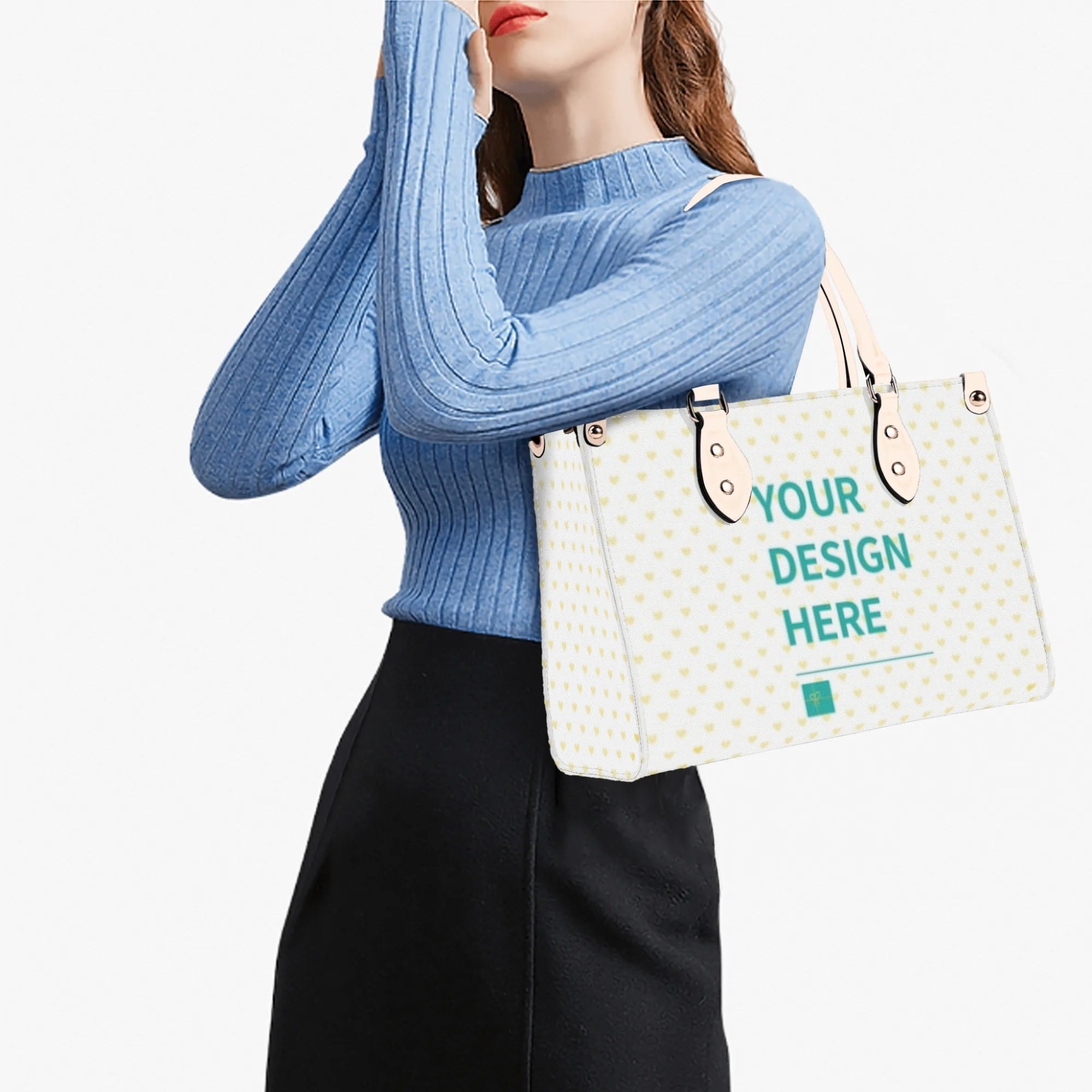 Personalized white tote bag with 'YOUR DESIGN HERE' text, heart pattern, and black handles. Ideal work bag.