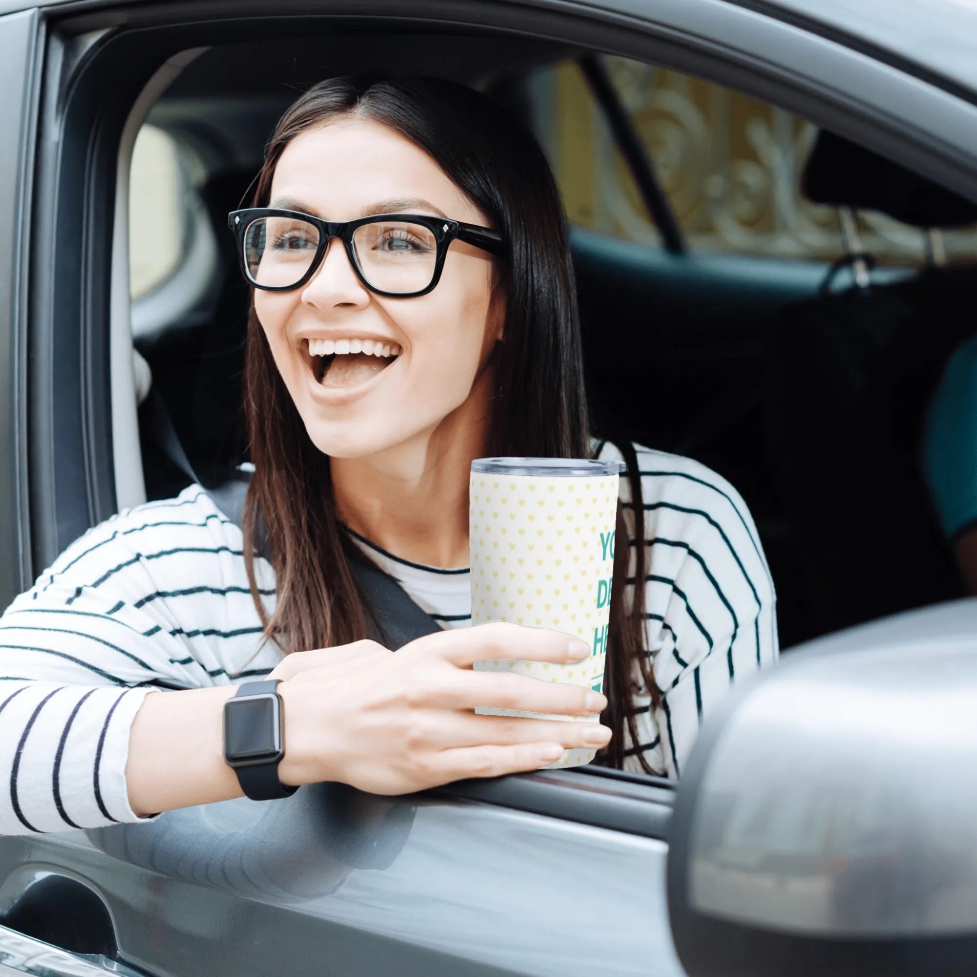 Woman in car holding personalized stainless steel travel tumbler, car coffee mug.