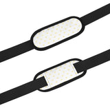 Personalized gym bag shoulder strap detail with yellow heart pattern, black strap, and shoulder strap.