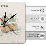 Square wooden wall clock with watercolor plants and 'grow' text; ideal for home or kitchen decor.